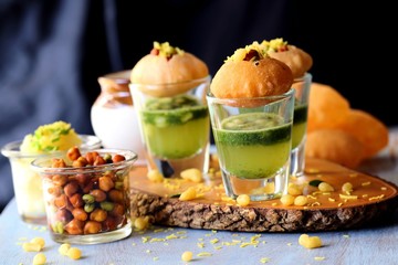 Pani Puri shots, Indian street snack made of fried puries, mint chutney, sprouts and boiled potatoes. Indian Chat