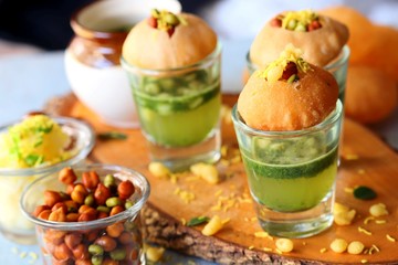 Pani Puri shots, Indian street snack made of fried puries, mint chutney, sprouts and boiled potatoes. Indian Chat