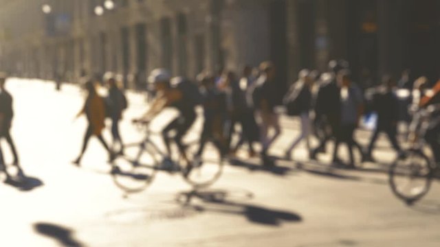 Anonymous crowd of people walking San Francisco street in the sun of morning. Slow motion