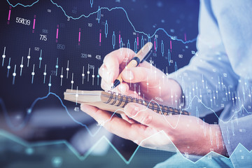 Double exposure hands with stock market chart.