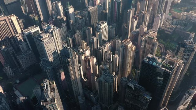 AERIAL. Cinematic video and Top view of Hong Kong city center at sunset and sun light.