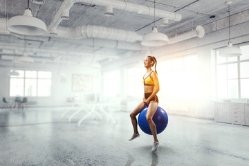Fototapeta na wymiar Sporty woman on fitness ball. Mixed media