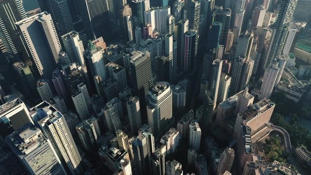 AERIAL. Cinematic video and Top view of Hong Kong city center at sunset and sun light.