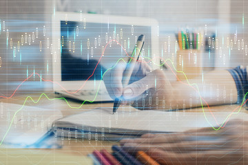 Financial forex charts displayed on woman's hand taking notes background. Concept of research. Double exposure