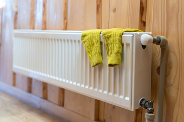 Modern radiator in room with wooden wall and cozy interior