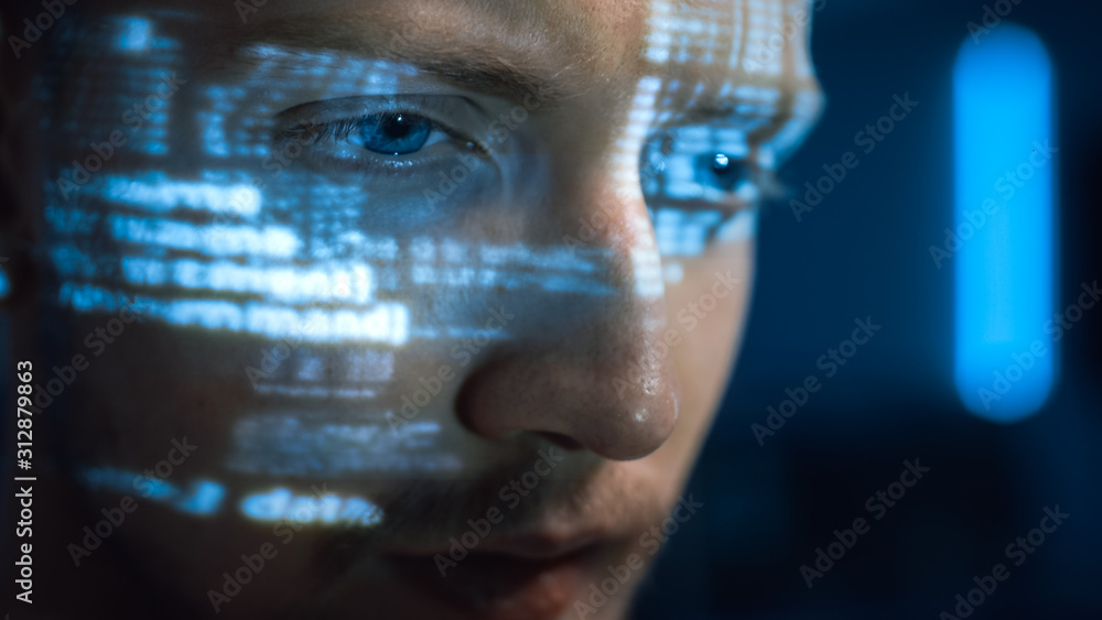 Poster Portrait of Software Developer / Hacker Working on Personal Computer, Projected Code Numbers and Characters Reflect on His Face. Dark Room Full of Electronics. Hacking and Programming Concept