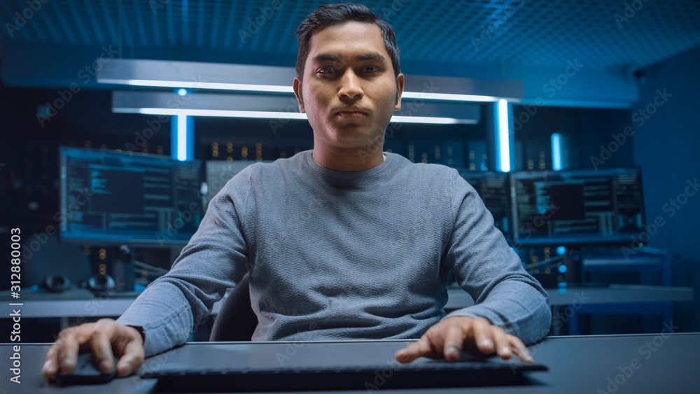 Poster Portrait of Software Programmer Sitting at His Desk and Working on Computer in Digital Identity Cyber Security Data Center. Hacking or Programming.