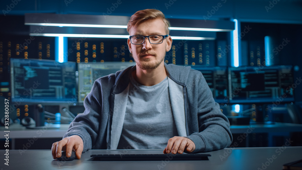 Poster Portrait of Software Developer / Hacker Wearing Glasses Sitting at His Desk and Working on Computer in Digital Identity Cyber Security Data Center. Hacking or Programming.