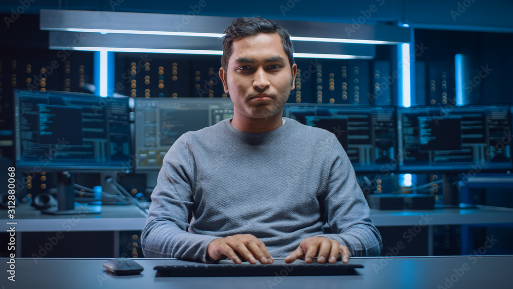 Poster Portrait of Software Programmer Sitting at His Desk and Working on Computer in Digital Identity Cyber Security Data Center. Hacking or Programming