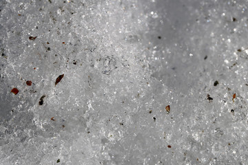Clean white snow in a closeup during springtime in Finland. In this photo you can see melting clean snow, beautiful even surface. Color macro image. Seasonal background photo.
