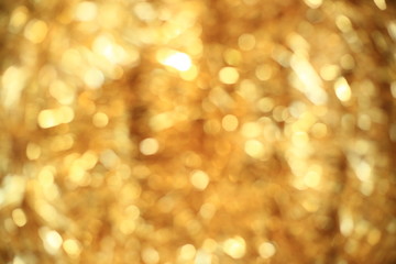 Gold bokeh lights backgrounds. Glittering golden color decorative lighting copy space for luxury product placement. Design graphic resource.