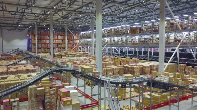 Boxes on a conveyor belt in a large automated warehouse