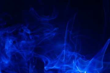 Blue smoke on black background.