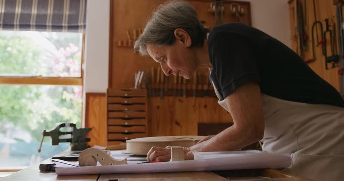 Female luthier at work in her workshop