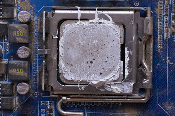 Clogged dust and dirt on the motherboard of a personal computer.