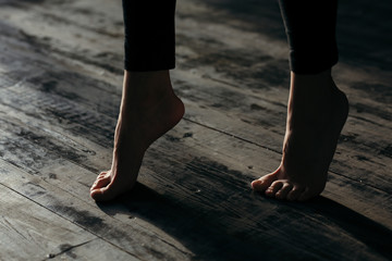 Female feet walking on warm heated floor close up view, barefoot girl legs going on hardwood living...