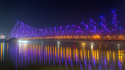 Howrah bridge (selective focus) - The historic cantilever bridge on the river Hooghly lit with purple and yellow lights