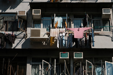 clothes hanging to dry , building facade in Hong Kong