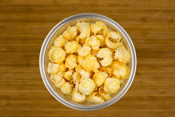  close up of popcorn in a plastic cup. fast food, junk-food and unhealthy eating concept.