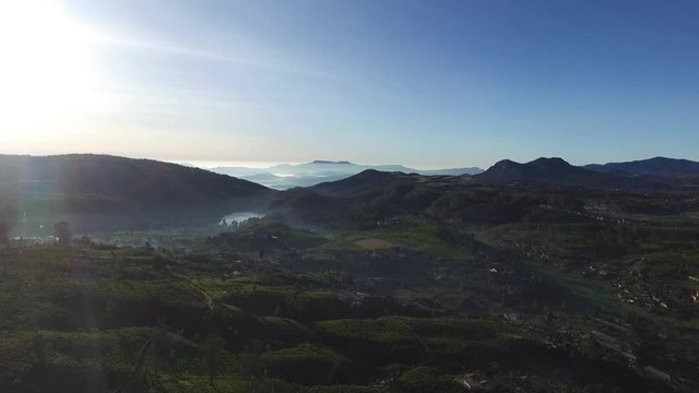 Picturesque tea plantation near Nuwara Eliya is city in hill country of Central Province, Upper Lake Road, Sri Lanka. Top view at sunrise