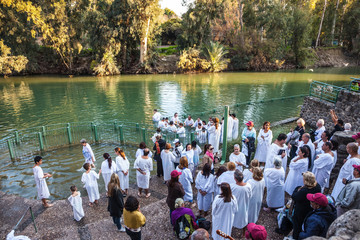 Christian pilgrims baptized dressed in white shirt - obrazy, fototapety, plakaty