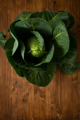 Head of green cabbage on wooden background