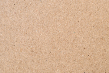 Light brown wrapping paper. Natural sheet surface, packaging background. Texture of cardboard, pasteboard, stiff paper.