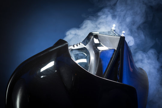 SAN BENEDETTO DEL TRONTO, ITALY. FEBRUARY 7, 2016.  Darth Vader replica helmet close up portrait. Lord Fener is a fictional character of Star Wars saga. Smoke and blue light background 