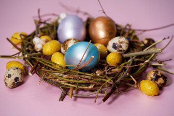 Easter eggs in nest on a pink background