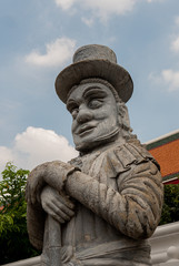 Ancient asian statue located in Wat Pho, the Reclining Buddha Temple. Bangkok, Thailand