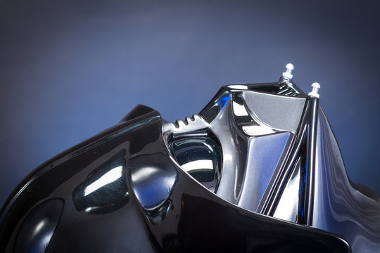 SAN BENEDETTO DEL TRONTO, ITALY. FEBRUARY 7, 2016.  Darth Vader replica helmet close up portrait. Lord Fener is a fictional character of Star Wars saga. Smoke and blue light background 