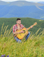 Naklejka na ściany i meble Acoustic music. Man with guitar on top of mountain. Summer music festival outdoors. Playing music. Sound of freedom. Inspired musician play rock ballad. Compose melody. Inspiring environment