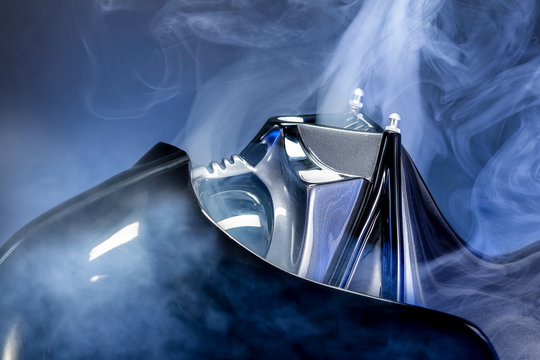 SAN BENEDETTO DEL TRONTO, ITALY. FEBRUARY 7, 2016.  Darth Vader replica helmet close up portrait. Lord Fener is a fictional character of Star Wars saga. Smoke and blue light background 