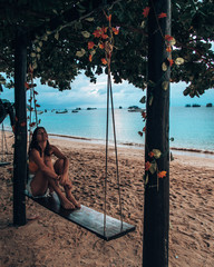 Girl playing on Swing at thailand beach in Koh Tao