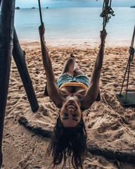 Girl playing on Swing at thailand beach in Koh Tao