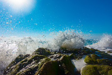 A surge of surf waves on a rocky shore