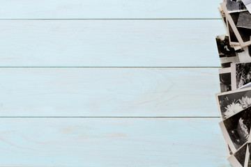 Old photos on a wooden table. Mockup free.Copy space.
