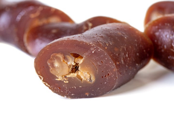 Georgian homemade churchkhela with walnuts and grape juice isolated on white