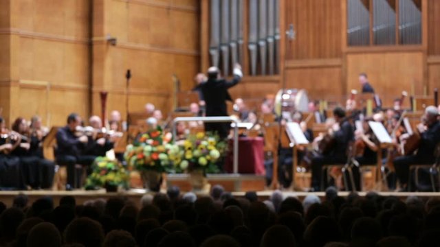 Out of focus (defocused) orchestra playing music