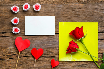 Red rose flower and gift box with copy space on wooden background. Valentine day concept 