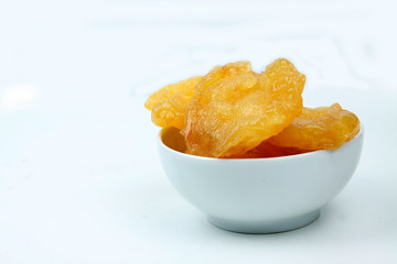 a bowl of dried pears isolated on white background. Horizontal image