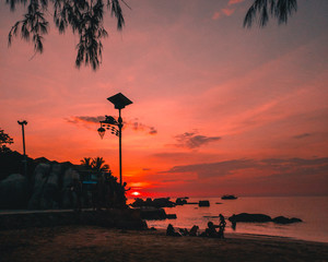 Red/pink/orange sunset at the beach in koh tao thailand