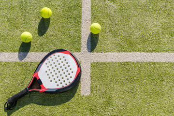 top view of paddle racket and balls on turf