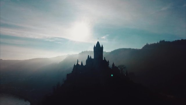 Aerial video of a european Castle with sun in background