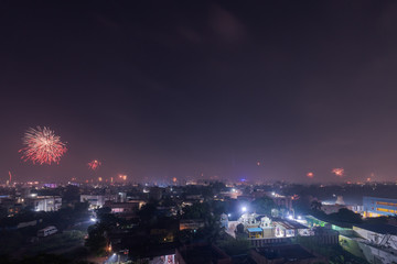 Fototapeta na wymiar Bursting fireworks during the Divali festival of light over the city of Chennai in South India