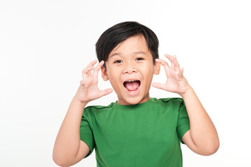 Attention! Portrait of cute boy is holding hand near his open mouth and screaming, isolated on white background.