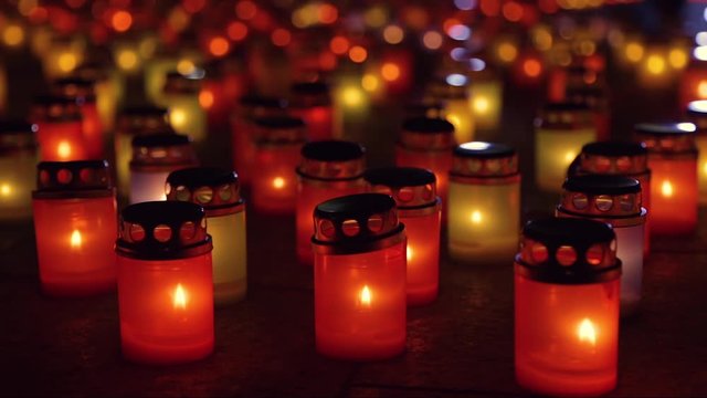Mass candle light vigil. Feeling of sadness, pain and suffering. Many burning lanterns on memory. Laterns represent the memories of loved ones. People light lanterns to remember loved ones.
