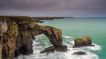 Fototapeta na wymiar The Green Bridge of Wales. A dramatic, coastal rock arch, located on the Pembrokeshire coastline, in South Wales.