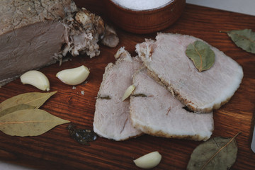 Fototapeta na wymiar baked ham with chapel, bay leaf and Italian herbs