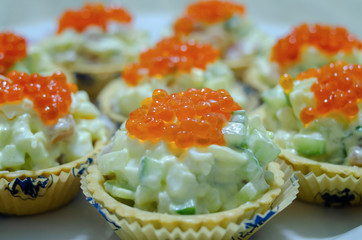 tartlets with salad and red caviar